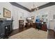 An elegant home office features a fireplace, dark wood floors, and a chandelier at 207 E Hightower E Trl, Social Circle, GA 30025