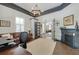 Office boasts a fireplace, gray trim, and glass doors leading to another room at 207 E Hightower E Trl, Social Circle, GA 30025