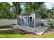 Stylish storage shed with double doors, windows, and a concrete pad for added functionality at 207 E Hightower E Trl, Social Circle, GA 30025