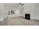 Spacious living room with gray carpet, white fireplace, and an open view to the kitchen at 2864 Parkway Close, Lithonia, GA 30058
