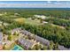 Expansive aerial view showcasing the residential area near a school with sports facilities at 3502 Village Green Dr, Roswell, GA 30075