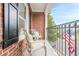 Charming brick balcony featuring wrought iron railings and comfortable seating overlooking the street at 3502 Village Green Dr, Roswell, GA 30075