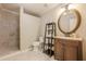 Modern bathroom with walk-in shower, decorative tile, vanity and shelving at 3502 Village Green Dr, Roswell, GA 30075