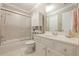 Well-lit bathroom with a tub-shower combination and a white vanity with ample storage at 3502 Village Green Dr, Roswell, GA 30075