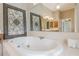 Relax in this large garden tub with jets, tile surround, and decorative mirrors at 3502 Village Green Dr, Roswell, GA 30075
