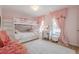 Cozy pink bedroom with white bunk beds, vanity, a soft rug, and pink accents create a charming space at 3502 Village Green Dr, Roswell, GA 30075