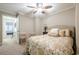 Comfortable bedroom with natural light, ceiling fan, and access to additional rooms at 3502 Village Green Dr, Roswell, GA 30075