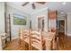 Spacious dining room features hardwood floors, rustic table and chairs, neutral walls, and a ladder decor element at 3502 Village Green Dr, Roswell, GA 30075