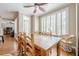 Large dining room with hardwood floors and bright light from the large window with shutters at 3502 Village Green Dr, Roswell, GA 30075