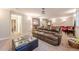 Finished basement with comfortable leather sofa, ottoman, and a view into adjoining entertainment area at 3502 Village Green Dr, Roswell, GA 30075