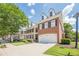 Beautiful multi-story townhomes with two car garages, brick exteriors and well maintained landscaping at 3502 Village Green Dr, Roswell, GA 30075
