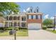 Classic brick home with a well-manicured lawn and a two-car garage in a suburban setting at 3502 Village Green Dr, Roswell, GA 30075