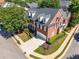 Stately brick townhome with manicured landscaping, a two-car garage, and a welcoming entryway at 3502 Village Green Dr, Roswell, GA 30075