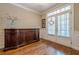 Bright foyer with wood floors, large window, decorative furniture, and elegant trim at 3502 Village Green Dr, Roswell, GA 30075