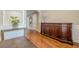 Inviting foyer featuring hardwood floors, console table, beautiful dark stained cabinet with decorative floral accents at 3502 Village Green Dr, Roswell, GA 30075