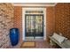 Inviting front entrance with a double door, brick surround, and decorative wreath for a warm, welcoming feel at 3502 Village Green Dr, Roswell, GA 30075