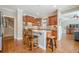 Elegant kitchen features stainless steel appliances, wood cabinets, granite countertops, and breakfast bar with seating at 3502 Village Green Dr, Roswell, GA 30075