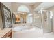 This bathroom features a large tub, a walk-in shower, and a contemporary decorative mirror at 3502 Village Green Dr, Roswell, GA 30075