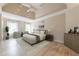 Spacious bedroom featuring tray ceilings, a ceiling fan, and lots of natural light at 3502 Village Green Dr, Roswell, GA 30075