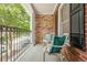 Inviting front porch with brick columns and comfortable seating at 3502 Village Green Dr, Roswell, GA 30075