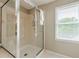 The bathroom's walk-in shower features custom tile and a built-in seat at 3502 Village Green Dr, Roswell, GA 30075