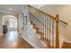 Elegant staircase with carpeted steps, wooden handrail, and decorative iron balusters leading to the upper level at 3502 Village Green Dr, Roswell, GA 30075