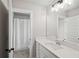 Modern bathroom with a white vanity, quartz countertop, and a large mirror reflecting the adjacent shower at 2362 Browns Mill Rd, Atlanta, GA 30315