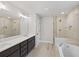 A luxurious bathroom featuring a soaking tub, walk-in shower, and a double vanity at 2362 Browns Mill Rd, Atlanta, GA 30315