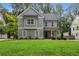Charming two-story home with gray siding, a manicured lawn, and a welcoming front porch at 2362 Browns Mill Rd, Atlanta, GA 30315