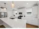A modern kitchen featuring white cabinets, stainless steel appliances, and a large central island at 2362 Browns Mill Rd, Atlanta, GA 30315