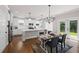 Open-concept kitchen with white cabinetry, stainless steel appliances, and a kitchen island at 2362 Browns Mill Rd, Atlanta, GA 30315