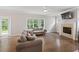 Cozy living room with a modern fireplace, large windows, and hardwood flooring at 2362 Browns Mill Rd, Atlanta, GA 30315