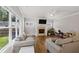 Bright living room with hardwood floors, a modern fireplace, and large windows overlooking the yard at 2362 Browns Mill Rd, Atlanta, GA 30315