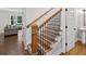 Staircase features hardwood steps and black iron balusters between the first and second floor at 2362 Browns Mill Rd, Atlanta, GA 30315