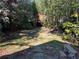 Charming backyard features a unique treehouse, complemented by a stone walkway and lush greenery at 284 Lakeview Ne Ave, Atlanta, GA 30305