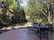 Beautiful backyard with wooden deck and dining area, features a charming treehouse nestled among the trees at 284 Lakeview Ne Ave, Atlanta, GA 30305