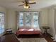 Bedroom featuring three windows offering natural light, hardwood floors, and a wrought iron bed at 284 Lakeview Ne Ave, Atlanta, GA 30305