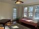 Sunlit bedroom features hardwood floors, ceiling fan, and large windows with a view at 284 Lakeview Ne Ave, Atlanta, GA 30305
