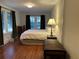 Bedroom featuring hardwood floors, two windows, dark green curtains and a vintage trunk at 284 Lakeview Ne Ave, Atlanta, GA 30305