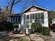 Charming home featuring a screened porch and landscaped front yard with mature trees at 284 Lakeview Ne Ave, Atlanta, GA 30305