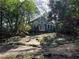 Charming exterior view with a backyard sitting area and stone walkway that leads to the home's entrance at 284 Lakeview Ne Ave, Atlanta, GA 30305