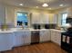 Well-lit kitchen with hardwood floors, white cabinets, and modern stainless steel appliances at 284 Lakeview Ne Ave, Atlanta, GA 30305
