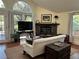 Bright living room with stone fireplace, arched window and hardwood floors, offers a warm and inviting space at 284 Lakeview Ne Ave, Atlanta, GA 30305