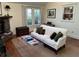 Cozy living room features a stone fireplace, hardwood floors, and a bright window for natural light at 284 Lakeview Ne Ave, Atlanta, GA 30305