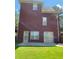 Spacious backyard featuring a patio, lawn, and a view of the home's brick exterior at 3008 Sunrise Ct, Conyers, GA 30094