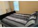 Comfortable bedroom with a striped grey comforter and a bright window providing natural light at 3008 Sunrise Ct, Conyers, GA 30094