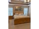 Spacious bedroom with a large window and light-colored wood furniture and a decorative mirror at 3008 Sunrise Ct, Conyers, GA 30094