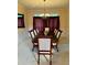 Formal dining room featuring a dark wood table and chairs with neutral striped fabric and a chandelier at 3008 Sunrise Ct, Conyers, GA 30094
