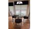Cozy dining room with modern chairs and a glass table, illuminated by a chandelier at 3008 Sunrise Ct, Conyers, GA 30094