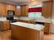 Well-equipped kitchen featuring wood cabinetry, stainless steel appliances, and a center island at 3008 Sunrise Ct, Conyers, GA 30094